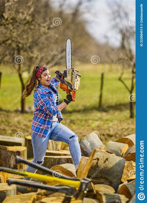 Woman Using Chainsaw To Cut A Log For Firewood Stock Image Image Of