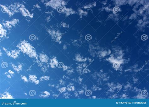 Bright Blue Skies With Wispy Cloud Serve As Background With Plenty Of