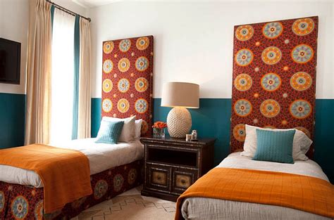 A moroccan fele is given to the bedroom with a whimsy blue bed, carved wooden tables and ornate mirrors. Moroccan Bedrooms Ideas, Photos, Decor And Inspirations