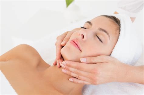 Premium Photo Close Up Of An Attractive Young Woman Receiving Facial Massage At Spa Center