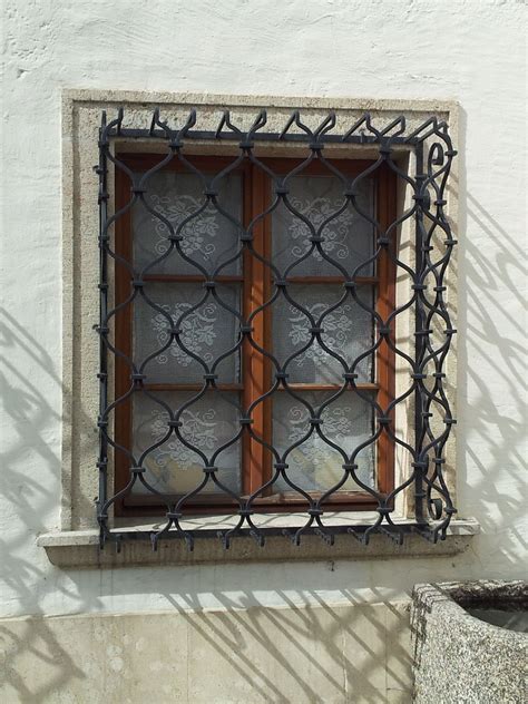 Classic Window With Cast Iron Ornamental Grid Protecting It Classic