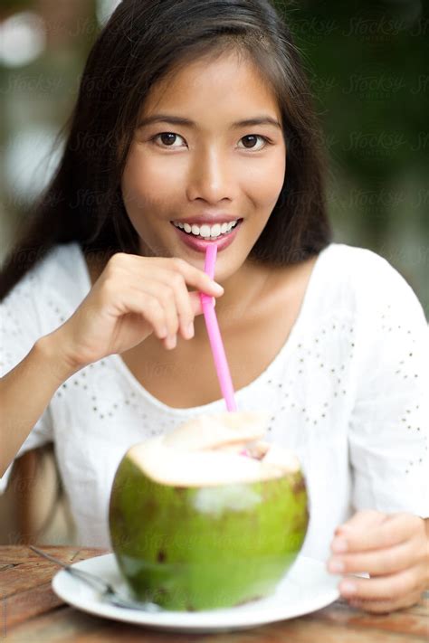 woman drinking coconut milk by lumina stocksy united