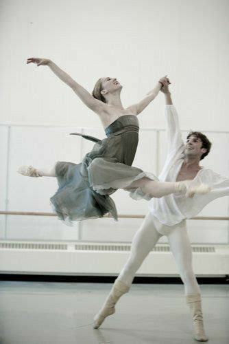 Two Ballerinas In White And Grey Tutus One Holding The Others Leg