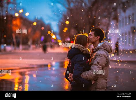 In Love Couple Kissing In The Snow At Night City Street Filtered With