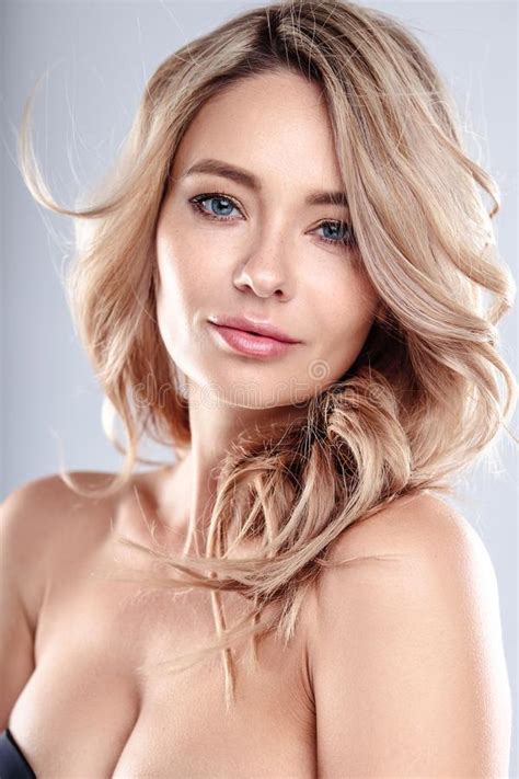 Blonde Young Woman With Healthy Curly Hair And Natural Make Up