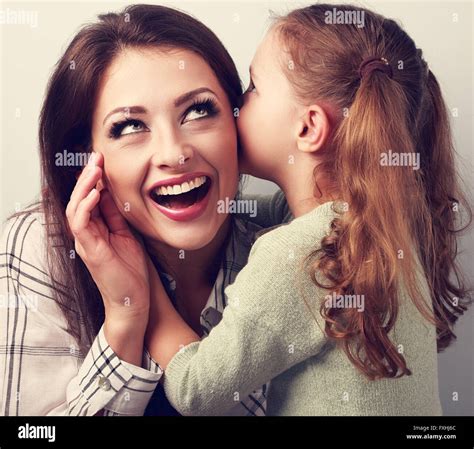 Happy Kid Girl Whispering The Secret To Her Very Surprising Mother In