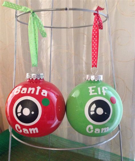 Two Christmas Ornaments Are Hanging On A Rack