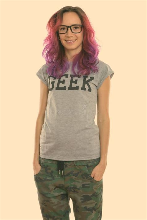Studio Shot Of Happy Geek Girl Smiling And Standing While Wearing