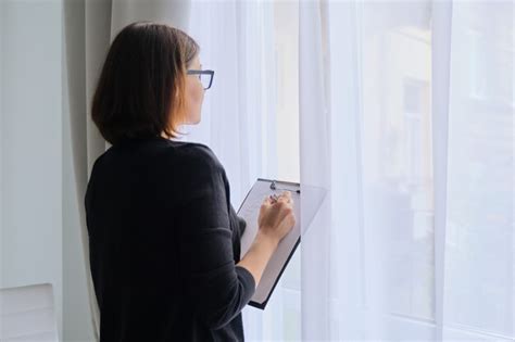 premium photo mature woman couch taking notes standing near window in office psychological