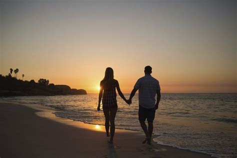 Couple Holding Hands While Walking On Beach Couples Beach Photography Couples Beach Scenes