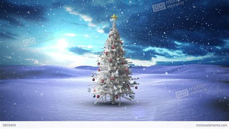 Snow Falling Christmas Tree In Snowy Landscape Stock