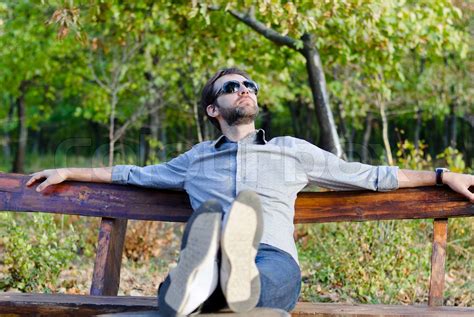 Young Man Relaxing On A Park Bench Stock Image Colourbox