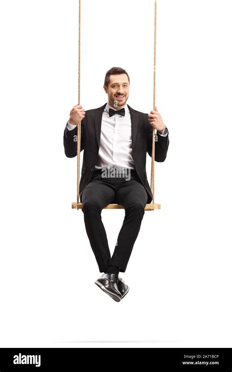 Elegant Man In A Suit Sitting On A Wooden Swing Isolated On White