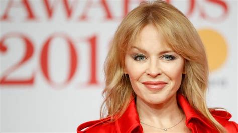 Brit Awards Kylie Minogue Turns Heads In Red Trench Coat The Advertiser