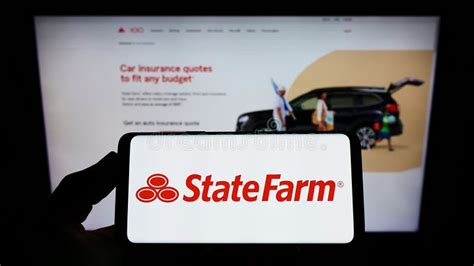 Person Holding Smartphone With Logo Of State Farm Mutual Automobile