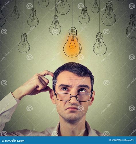 Portrait Thinking Man In Glasses Looking Up With Light Idea Bulb Above
