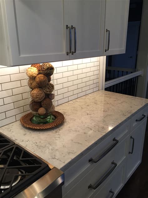 Quartz slab backsplashes offer some of the most neutral and even grained slabs available—so they are great if you want a minimalistic style or you are mixing a different look on the countertop. 3cm Viatera Quartz Rococo with subway tile backsplash, a ...
