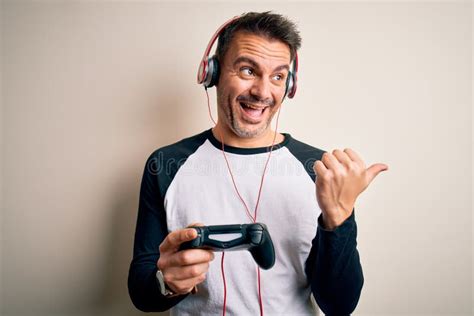 Young Handsome Gamer Man Playing Video Game Using Joystick And