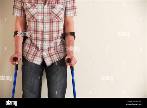 Man Walking Using Crutches Hi Res Stock Photography And Images Alamy