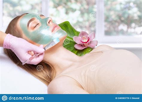 Beautician Makes A Face Mask Of A Woman To Rejuvenate The Skin Cosmetology Treatment Of Problem