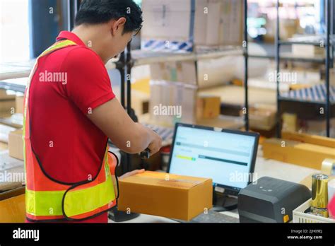 Asian Warehouse Man Worker With Computer And Barcode Scanner In