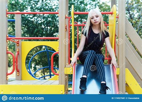 Sad Young Blonde Woman On Slide In Park On Blurred Background Stock Image Image Of Blonde