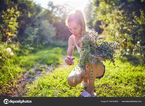 Woman Picking Flowers Herbs In Nature Stock Photo By Milangucci