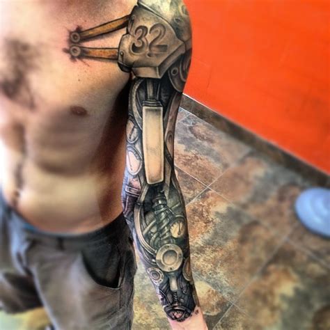 cool iron robot arm tattoo with shoulder strap tattooimages