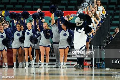 The Monmouth Hawk Mascot And Monmouth Hawks Cheerleaders Cheer During