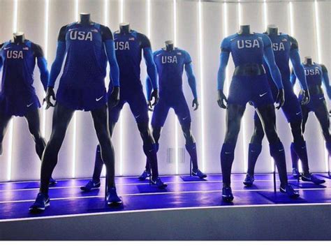 a group of mannequins are standing in front of a wall with the words usa on it