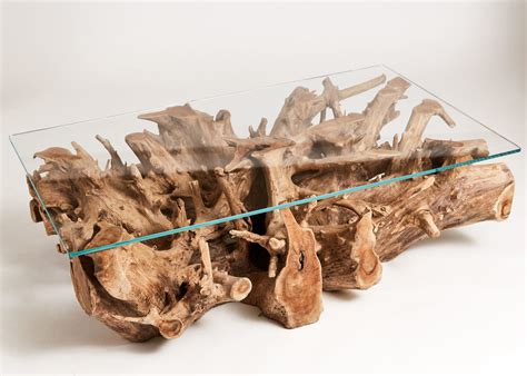 A fine coffee table featuring a unique base composed of natural finished cypress stumps and driftwood from medina lake texas. Teak Root Rectangular Coffee Table - Indigenous UK