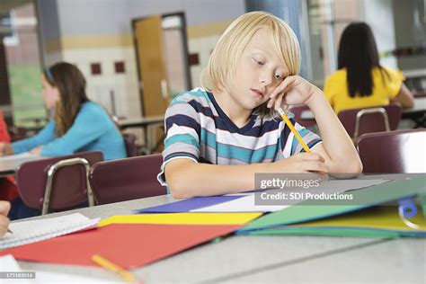 Bored Elementary Age School Student Doing His Homework High Res Stock