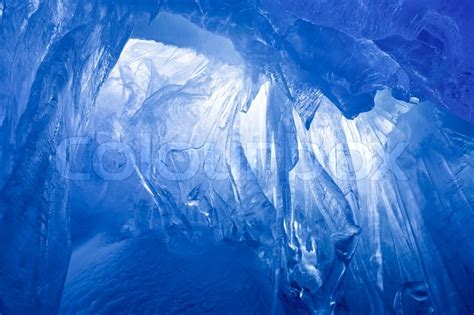 Blue Ice Cave Covered With Snow And Flooded With Light Stock Photo