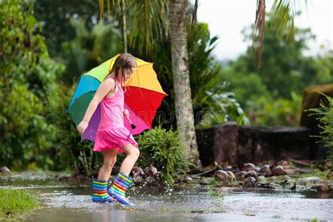 Kid With Umbrella Playing In Summer Rain Stock Photo Image Of