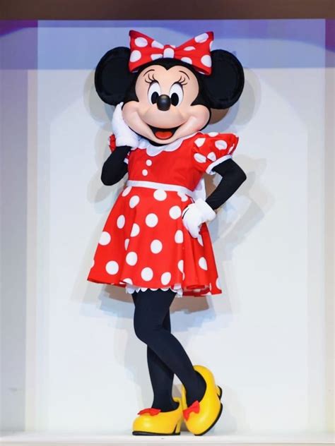 The Minnie Mouse Is Dressed In Red And White Polka Dots