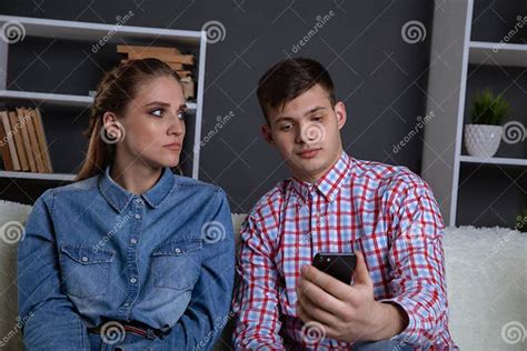 Bored Woman Sitting Near Her Man Missunderstood In The Couple Stock