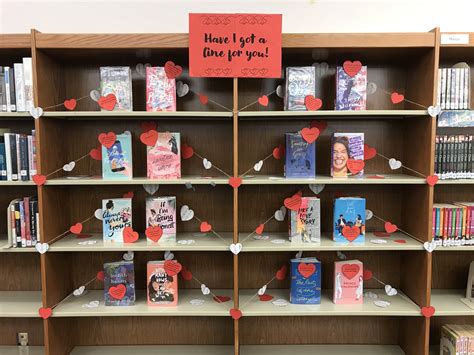 Several Books Are Arranged On Shelves In A Library With Paper Hearts