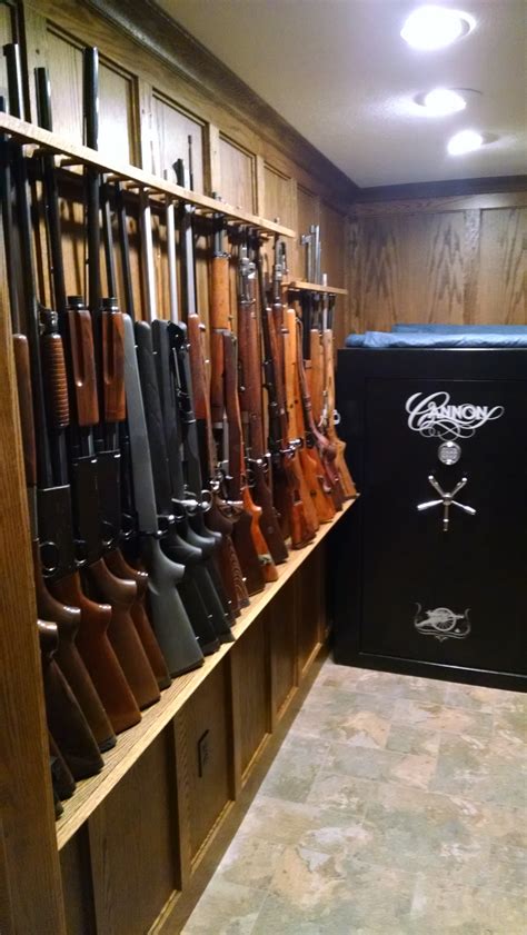 Gun cabinets artfully display a gun collection. Oak Library and Gun Room - John Hazelhoff Construction