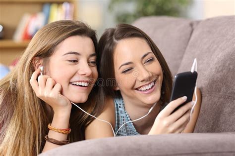 Two Friends Listening To Music Stock Photo Image Of Casual Friends