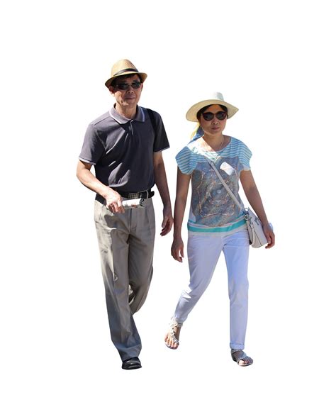 The Man And Woman Are Walking Down The Street Together Both Wearing