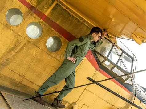 A Handsome Young Pilot Standing On The Wing Of A Plane Stock Image