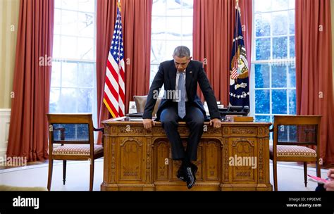President Barack On His Desk In The Oval Office Before A Conference
