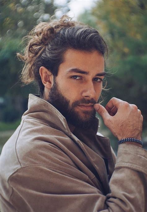 full messy man bun all hair is tied into one single man bun that is situated at the crown of