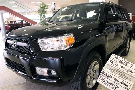 A Black Toyota Truck Is On Display In A Showroom