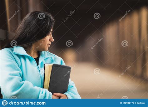 hispanic woman meditating while holding bible on a bridge stock image image of book spiritual
