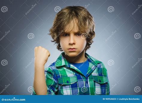 Angry Boy Isolated On Gray Background He Raised His Fist To Strike