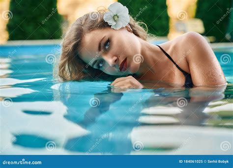 Model With Flower In Hair Relaxing In Pool Stock Image Image Of Cute
