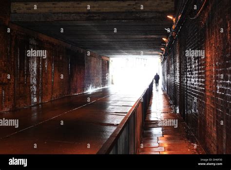 Man Walking Through Tunnel Stock Photo Alamy