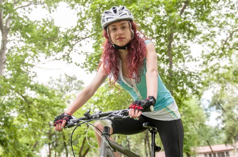 Beautiful Redhead Girl Riding And Cycling A Bike In A City Park — Stock