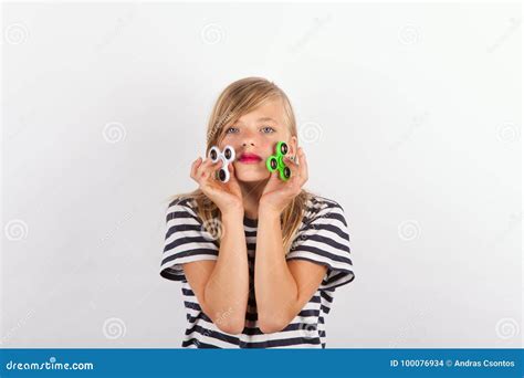 Girl Playing With Two Fidget Spinners Stock Photo Image Of Spinners